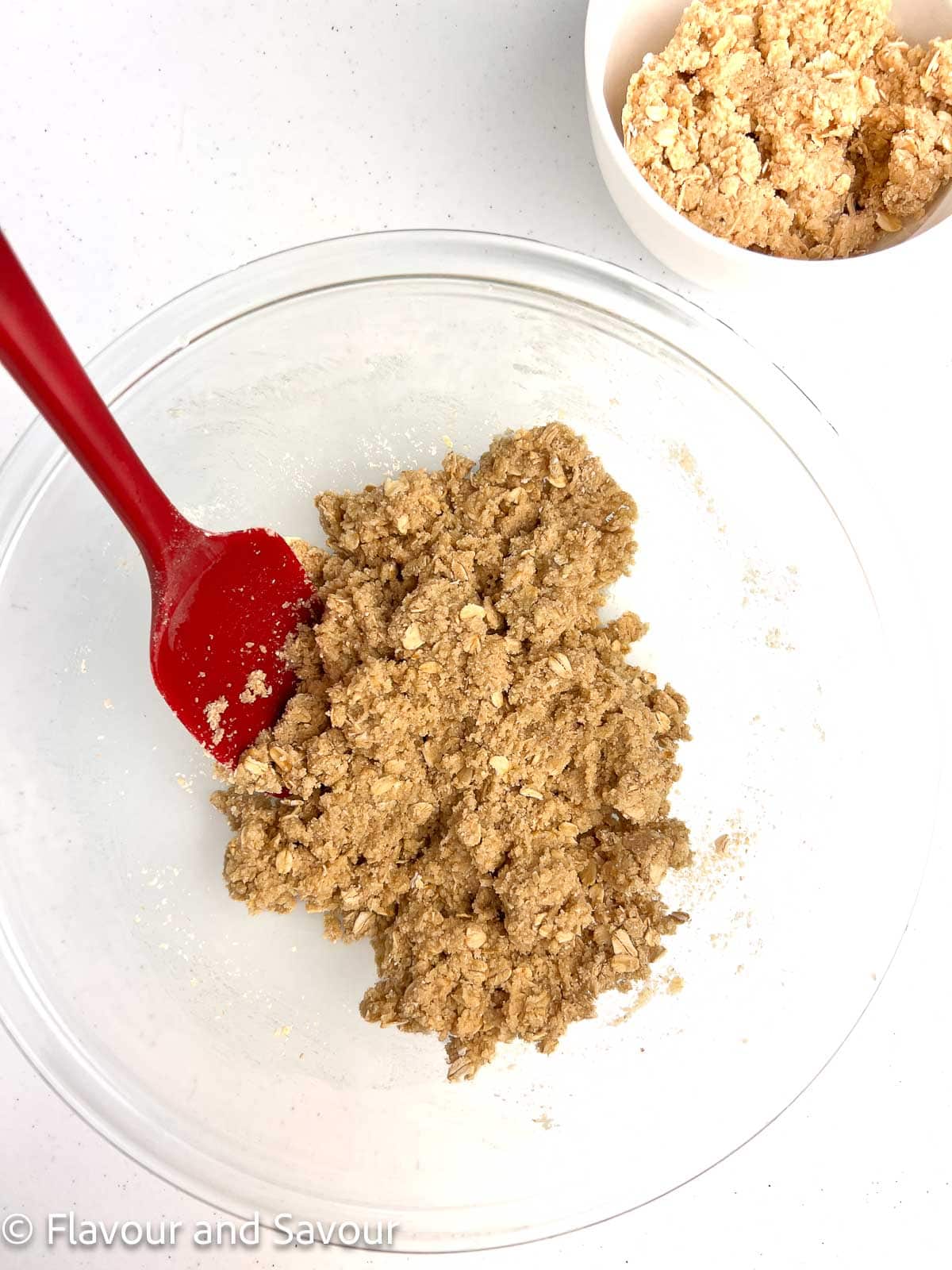 Crust mixture for cherry oat bars in a glass bowl.