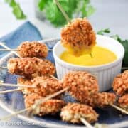 Shrimp fritters with a bowl of mango dipping sauce.
