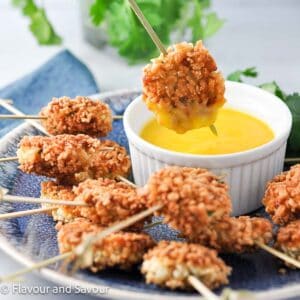 Shrimp fritters with a bowl of mango dipping sauce.