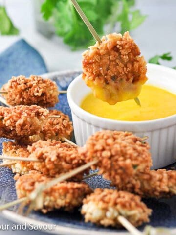 Shrimp fritters with a bowl of mango dipping sauce.