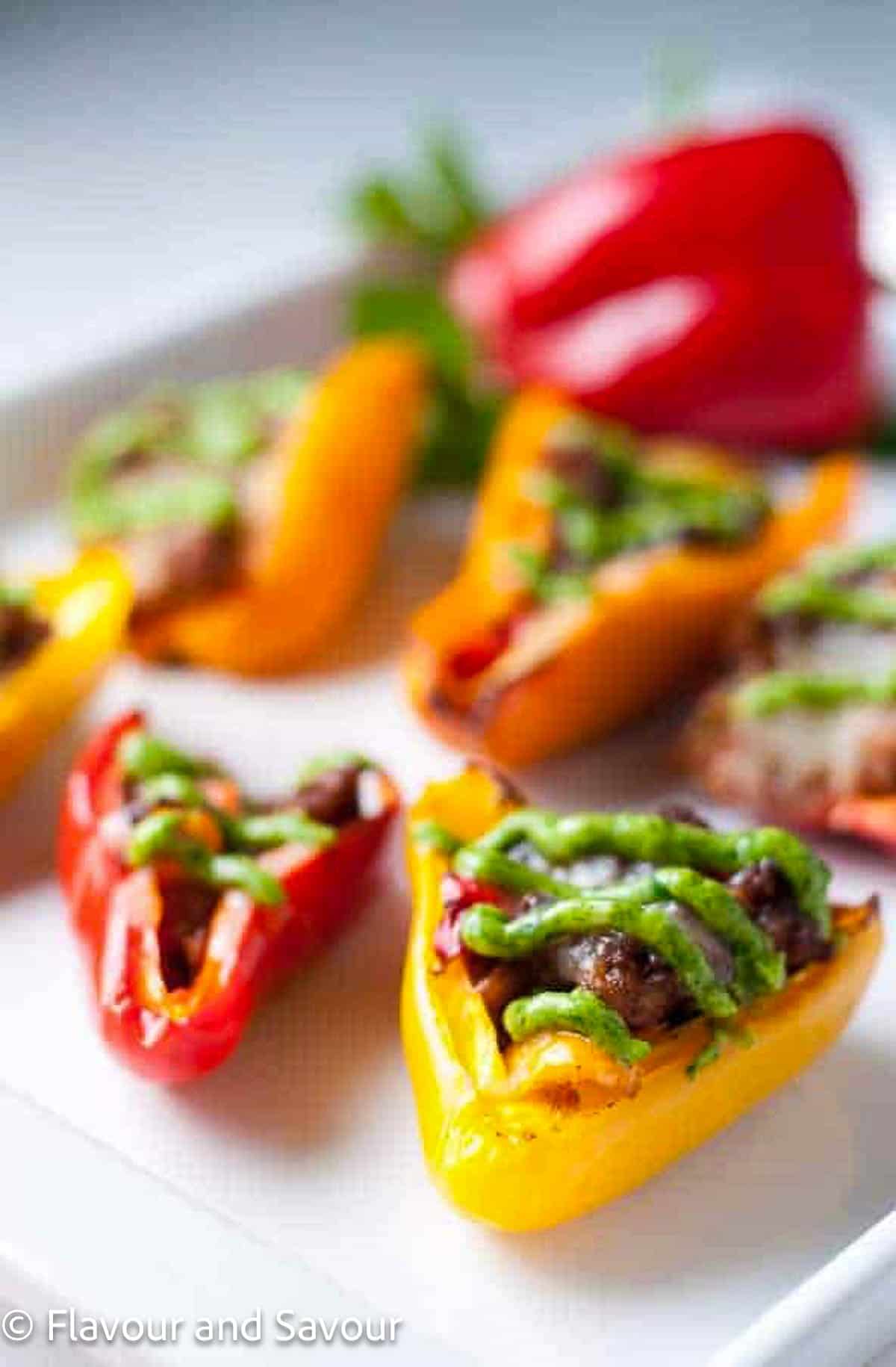 Mini bell peppers stuffed with taco seasoned meat and cheese.