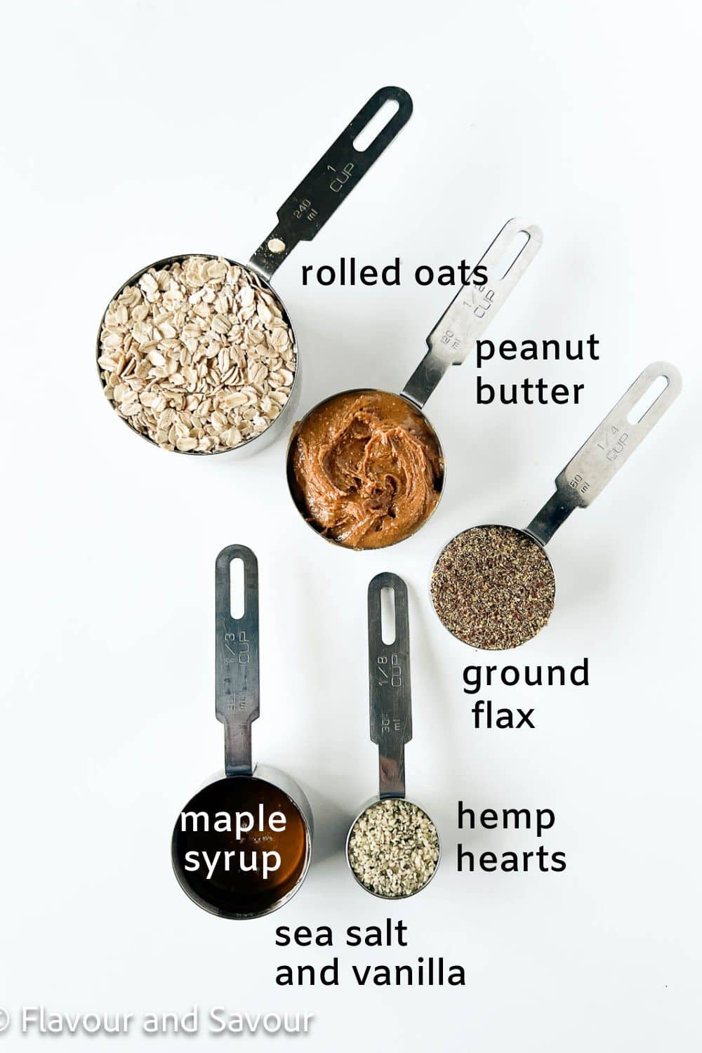 Labelled ingredients for no-bake oatmeal energy bites: rolled oats, peanut butter, ground flax, hemp hearts, maple syrup, vanilla and sea salt.