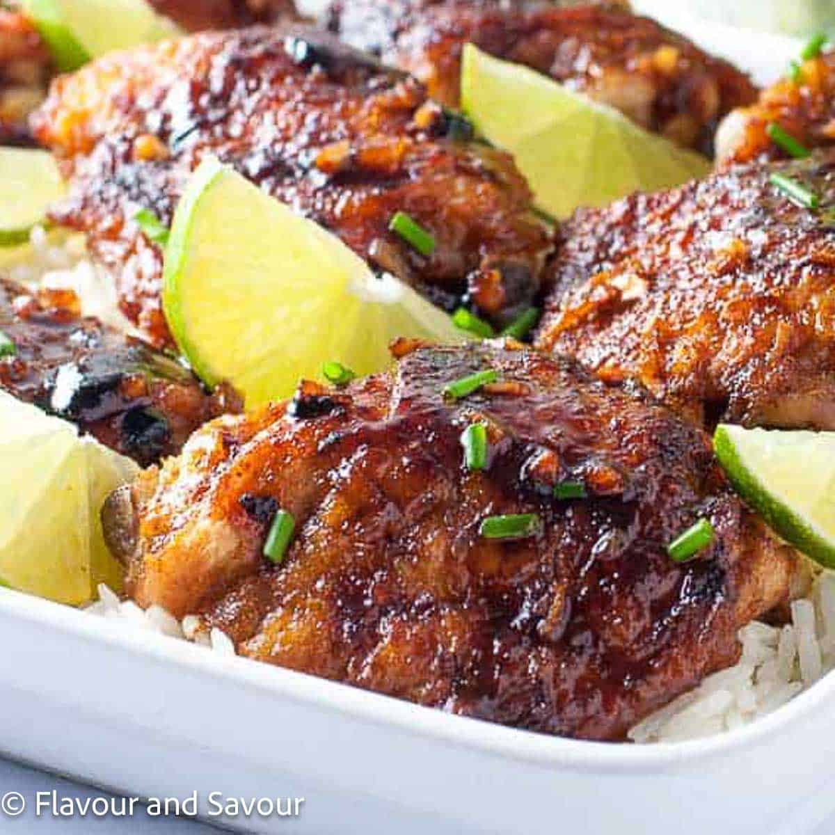 A platter of honey-lime chili chicken thighs on rice.