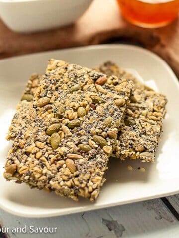 Oat crackers stacked on a plate.