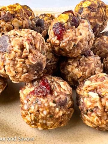 No-bake energy balls made with rolled oats, hemp hearts, chocolate chips and dried cranberries.