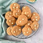 Gluten-free white chocolate macadamia nut cookies on a wire cooling rack.