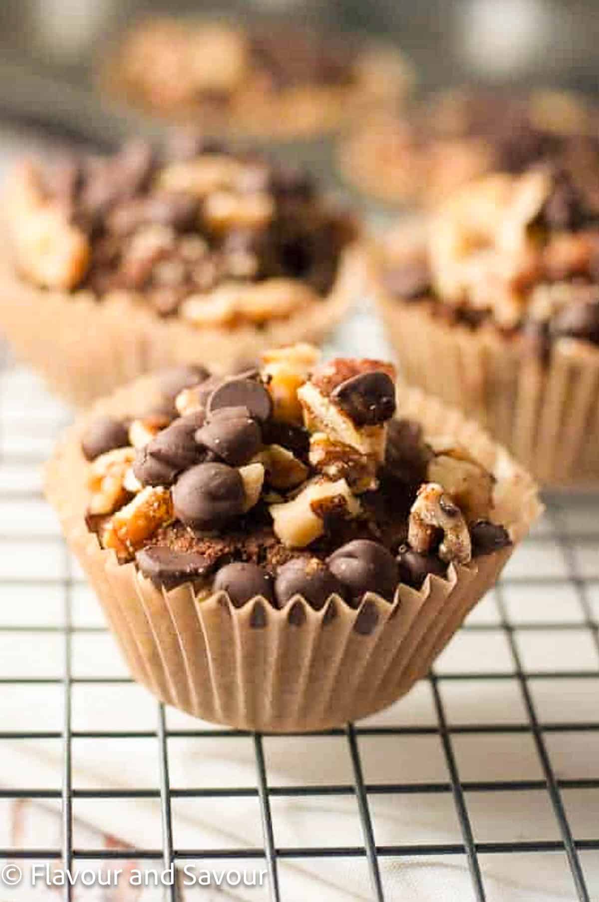 A chunky monkey muffin made with almond butter and bananas on a cooling rack.