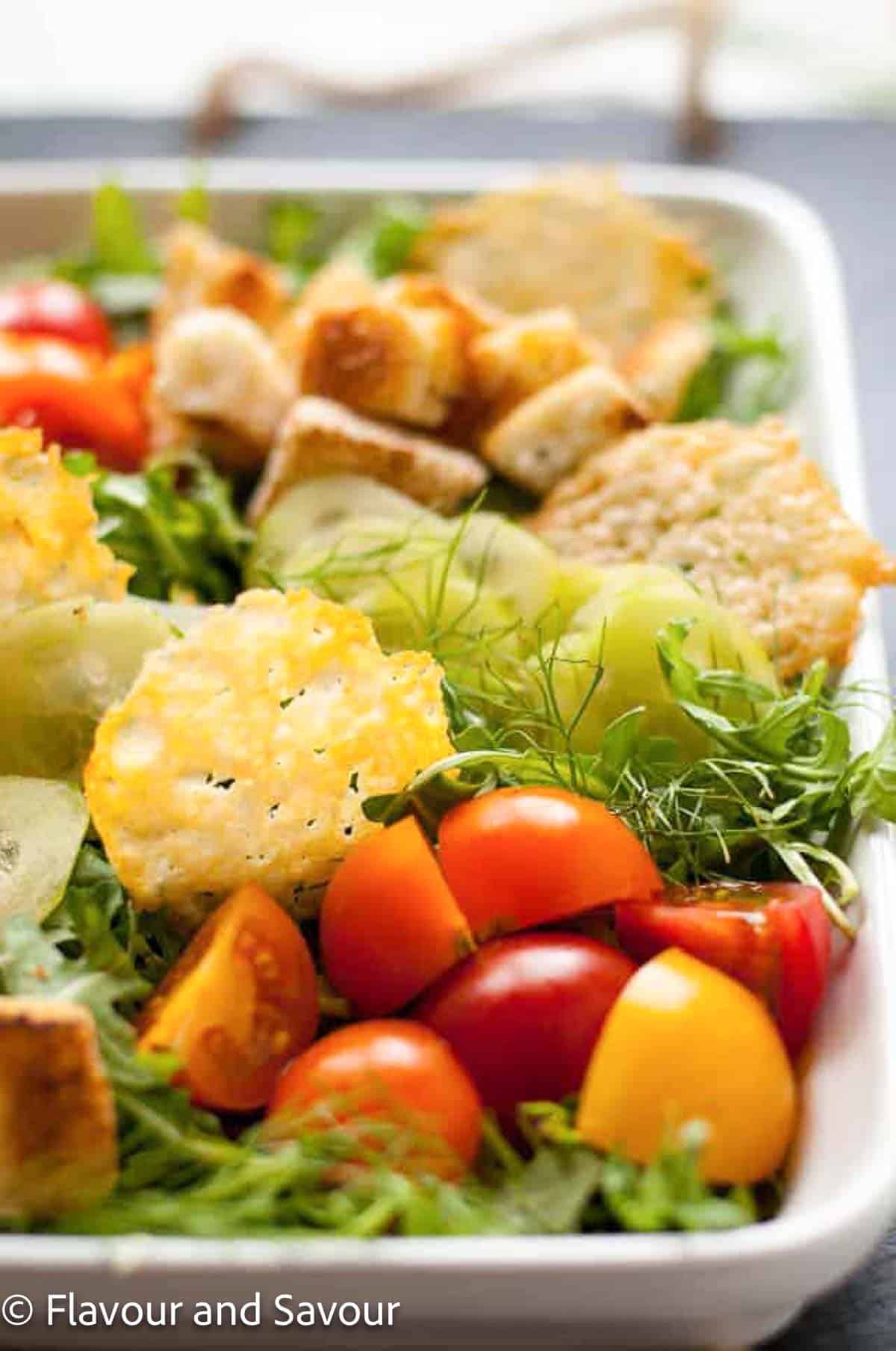 Parmesan crisps on a tossed green salad.