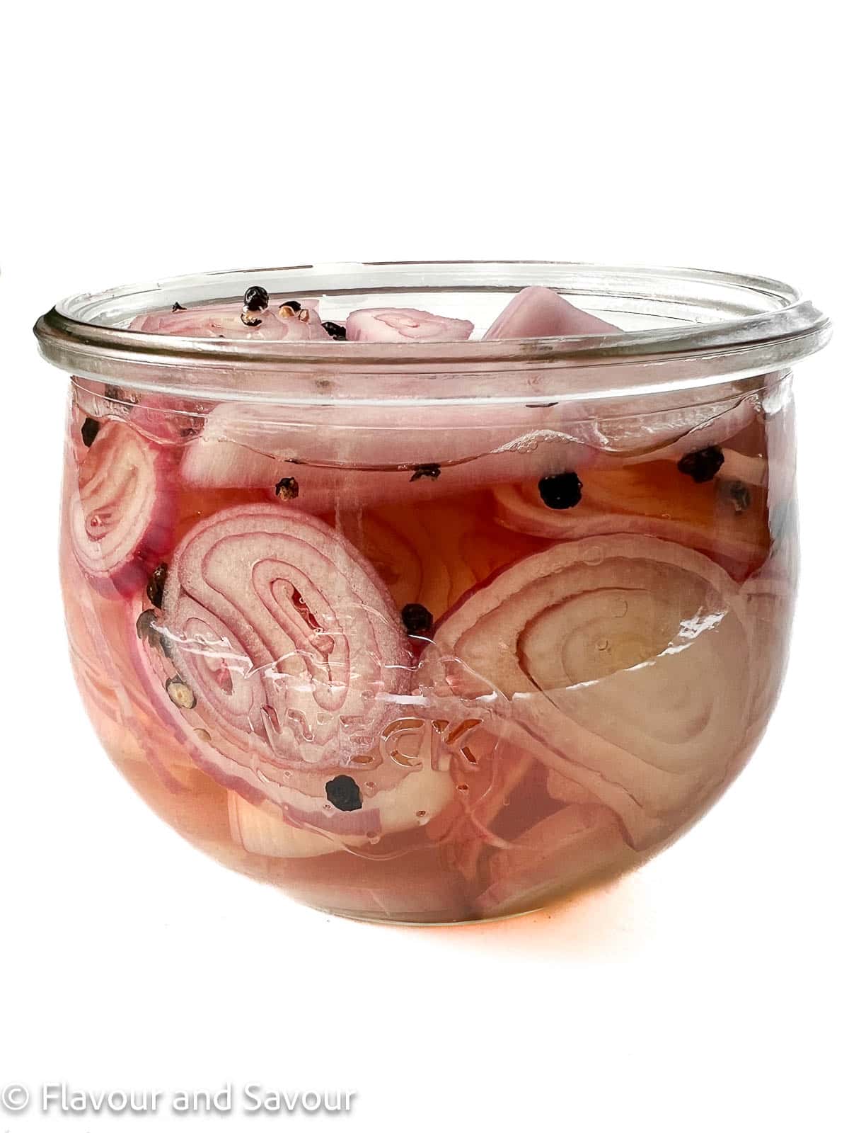 Quick pickled shallots in a Weck jar with peppercorns.