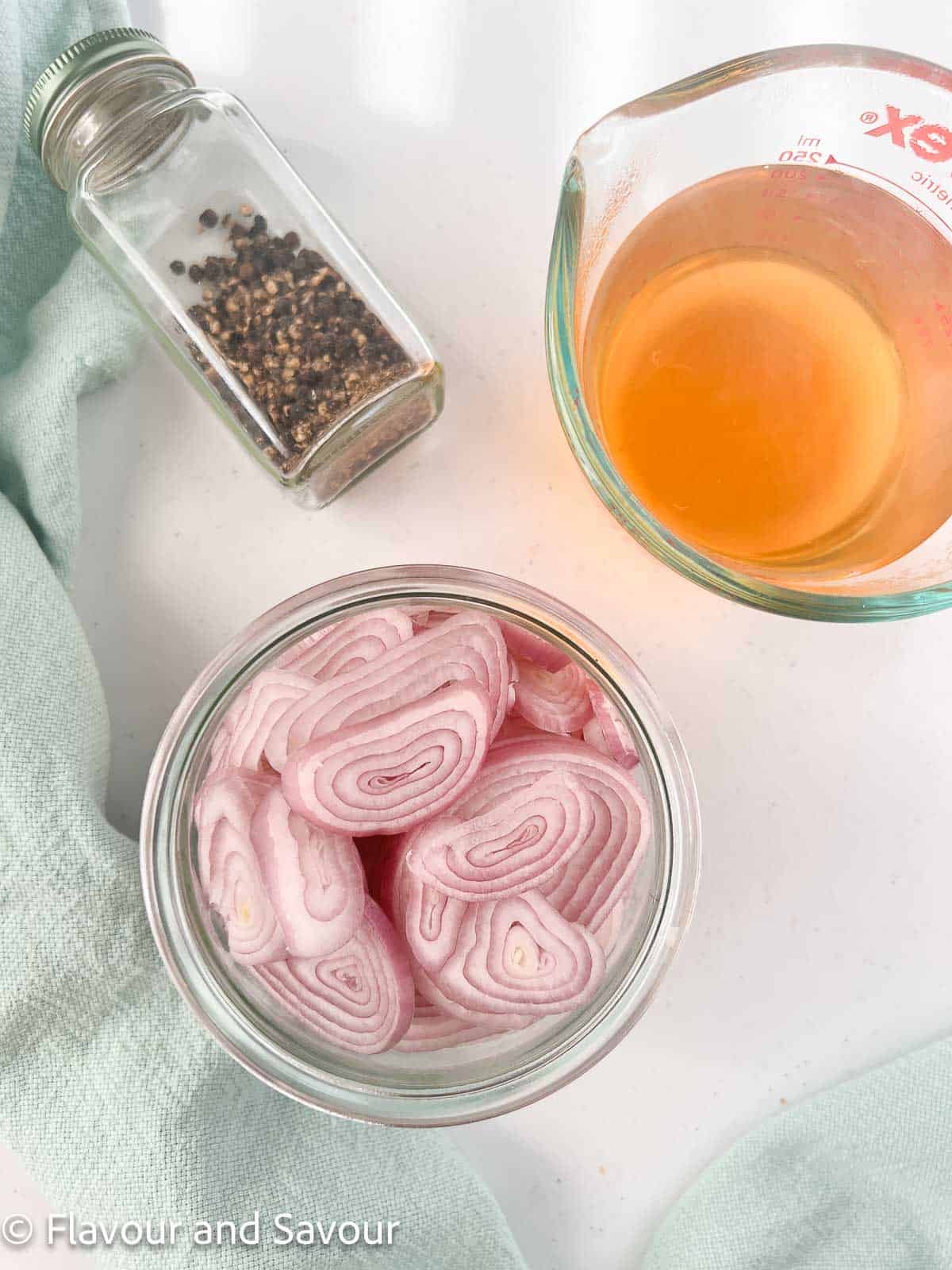 Ingredients for quick refrigerator pickled shallots: shallots, pickling brine, black peppercorns.